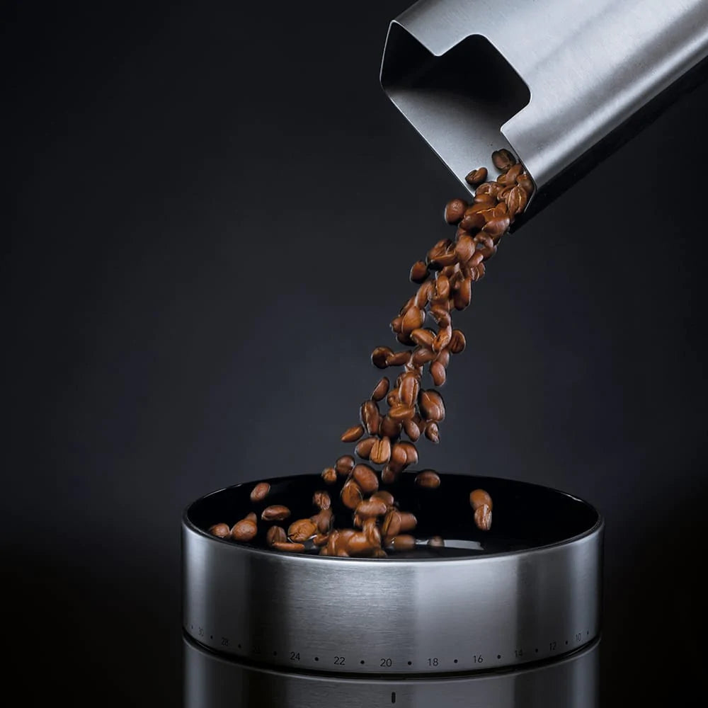 Pouring coffee beans into a Wilfa Uniform Grinder