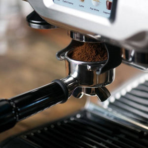 Sage Barista Touch Black Truffle grinding coffee into portafilter